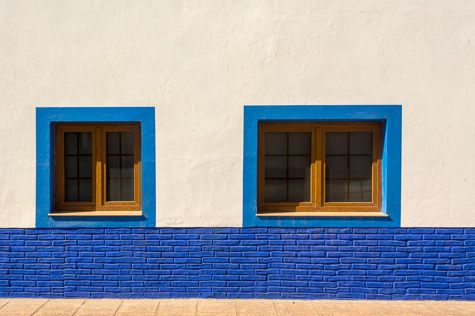Close-up of a painted house wall and window trim
