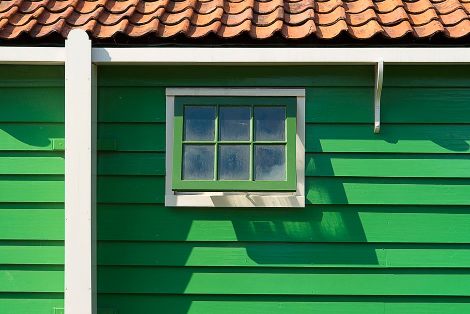 Close-up of a painted house wall and window trim