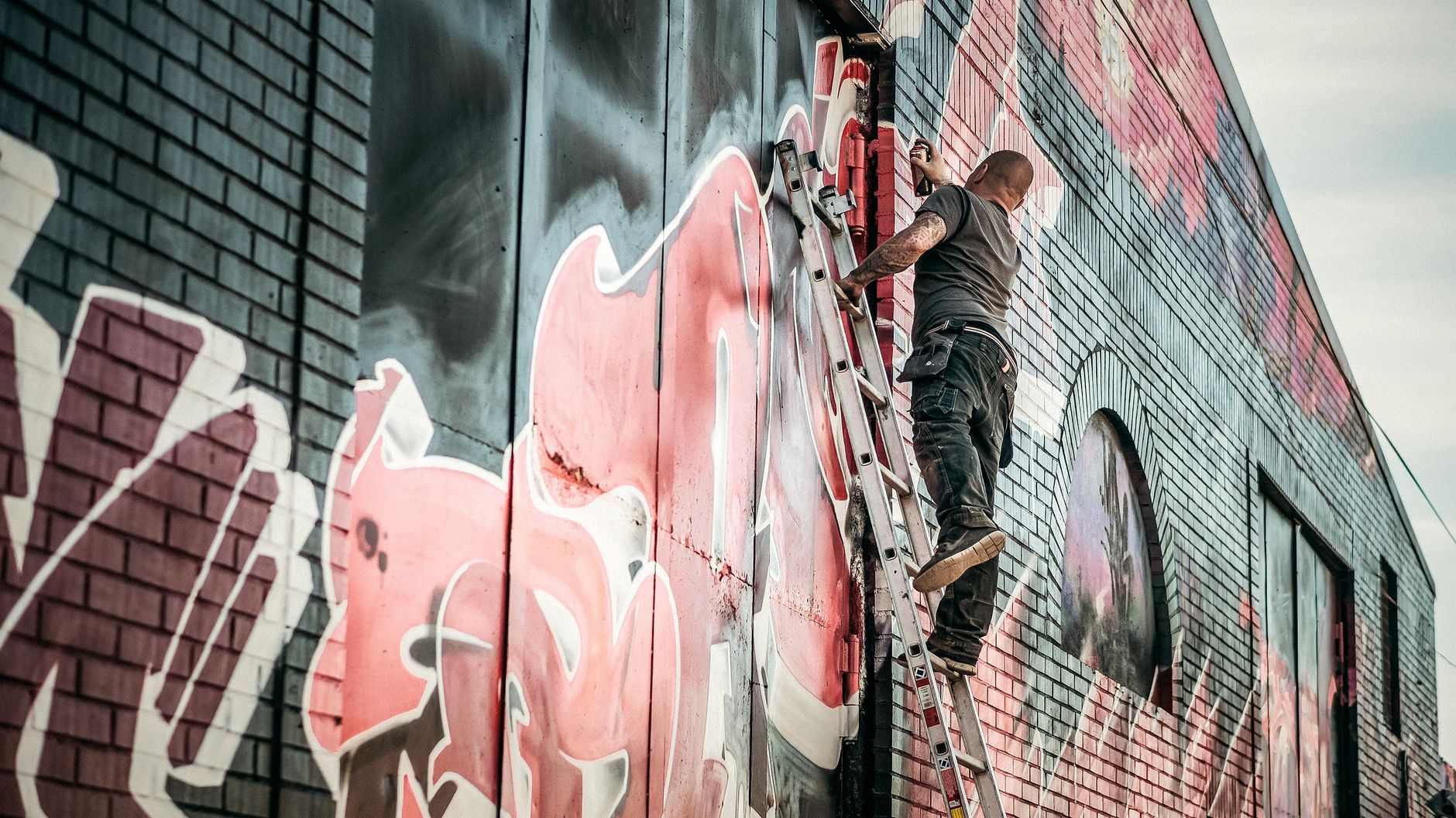 A person painting an exterior wall