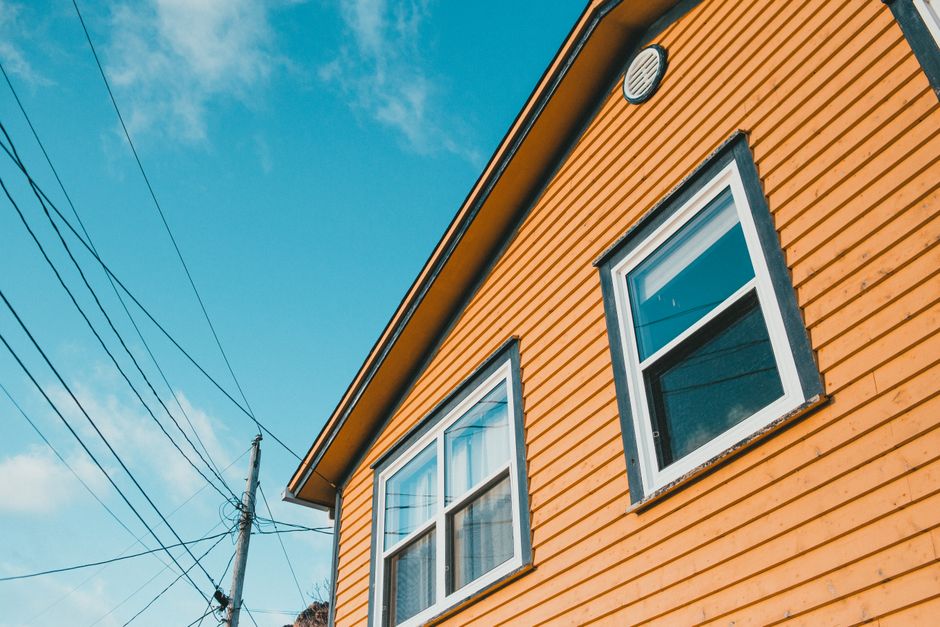 Close-up of a painted house wall and window trim